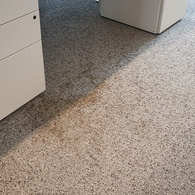 Coffee spill on office carpet at Group M’s London office before professional cleaning.