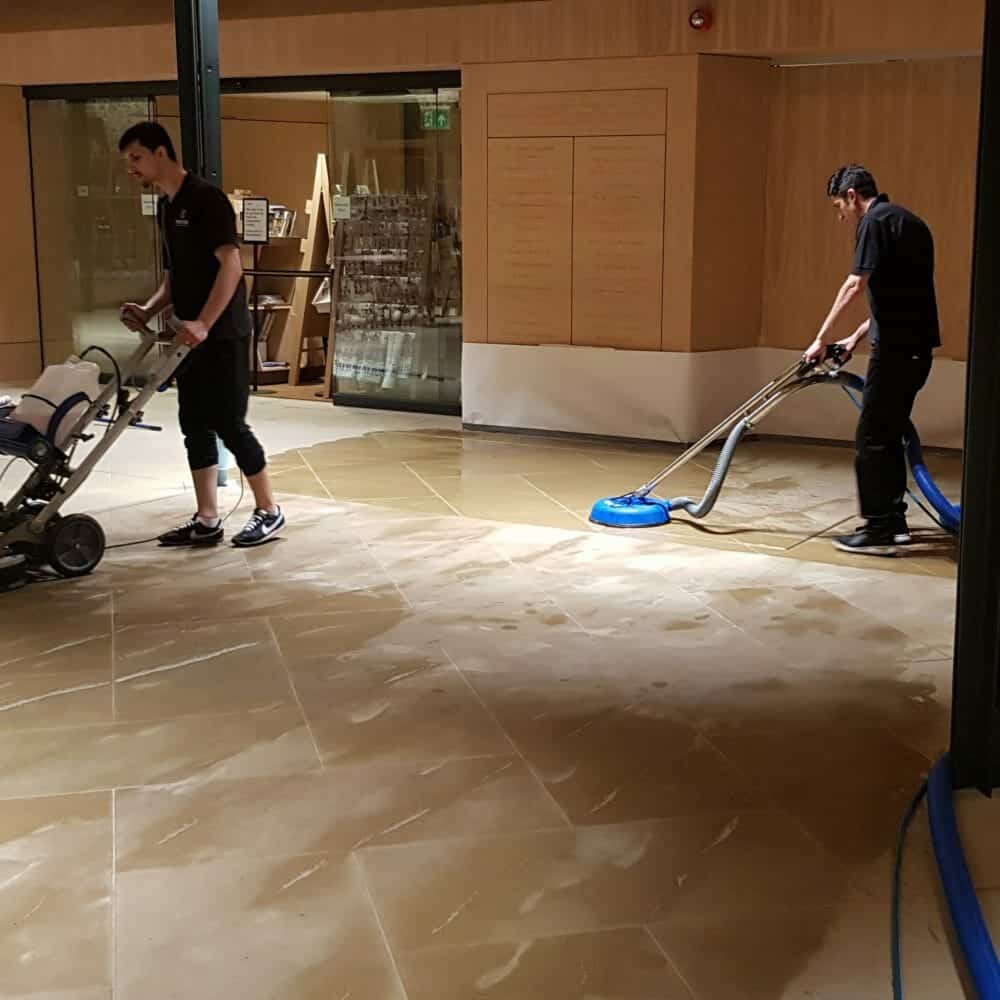 Abbey Cathedral Prestige stone technician using a mechanical orbital cleaner on Yorkstone at St Albans Abbey.