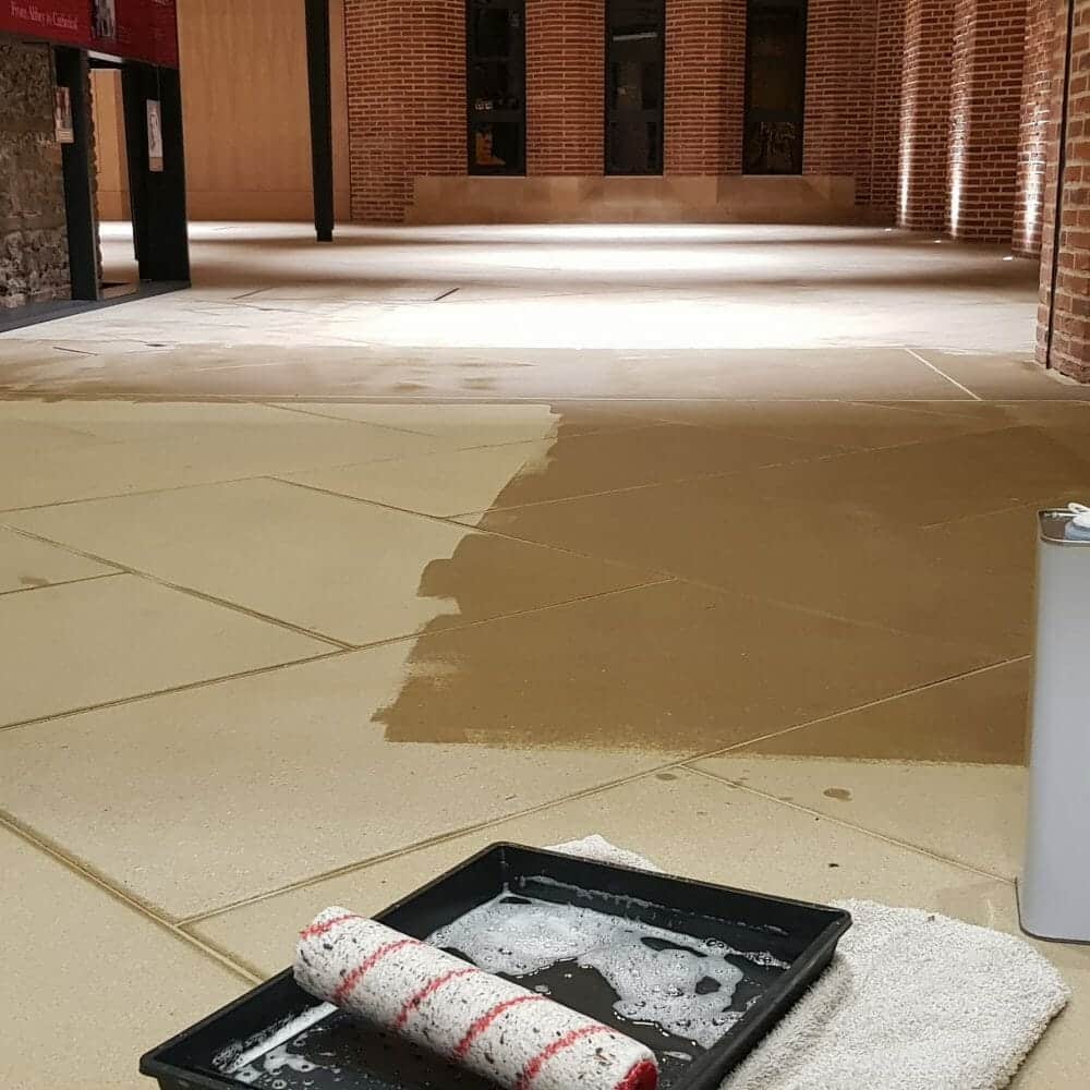 Lithofin Stain Stop Application - St Albans Specialist application of Lithofin Stain Stop floor seal on Yorkstone at St Albans Abbey, showing the contrast between the protected and untreated heritage stone.