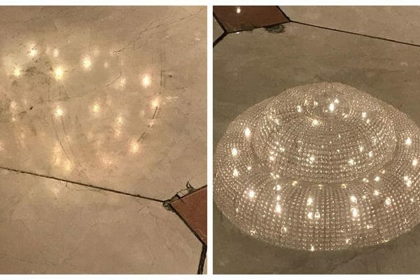 Marble floor reflecting chandelier before and after Orbot restoration