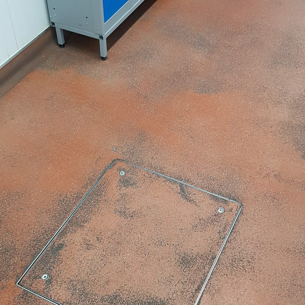 Heavily soiled high-traffic staff walkway at CP Foods production facility before specialist industrial cleaning.