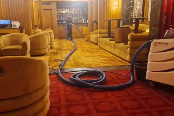 A wide-angle view of the members' area and bar at Langan's Brasserie during a deep restorative carpet clean by Prestige.