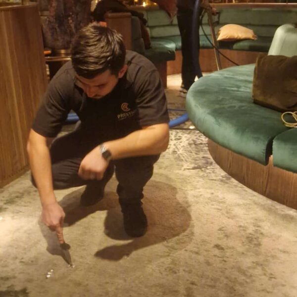Professional chewing gum removal from luxury restaurant carpets in London using Prochem Citrus Gel and specialized extraction tools.