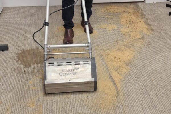 Prestige technician using a CRB machine and dry fibre compound to remove water stains at the Korea Tourism Office, Piccadilly, London.
