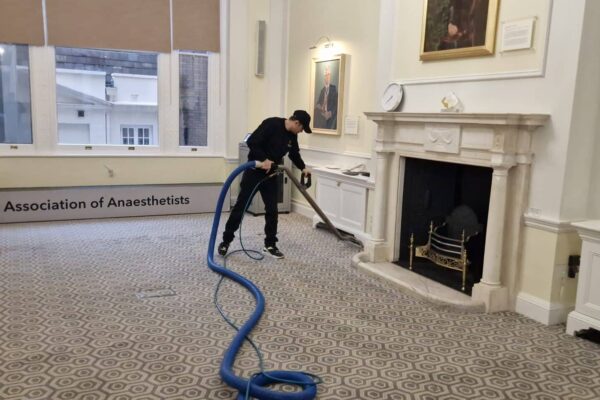 Prestige technician performing hot water extraction cleaning on 100% wool carpets at the Association of Anaesthetists, 21 Portland Place, London.