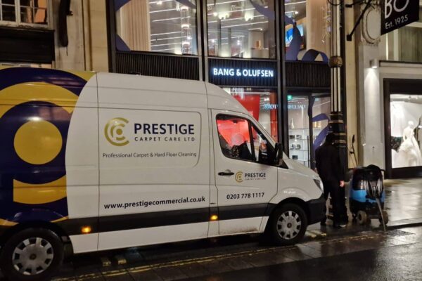 Prestige Commercial Carpet Cleaning van parked outside the Bang & Olufsen flagship store on New Bond Street, London, after a night-time carpet cleaning shift.