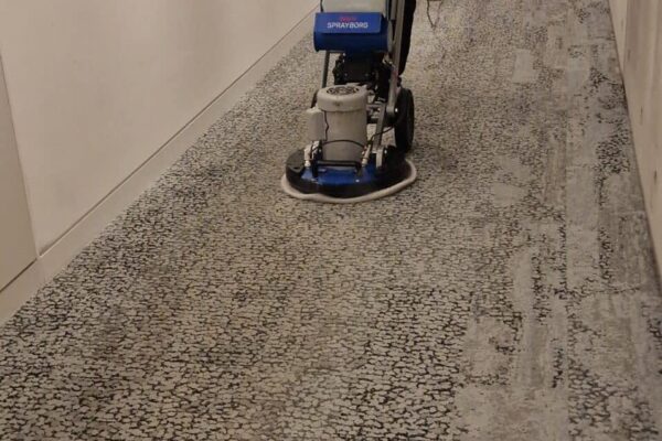 Prestige technician performing an annual out-of-hours office carpet clean for Alpha Group in W2 1DG, London, during the Christmas holiday downtime.