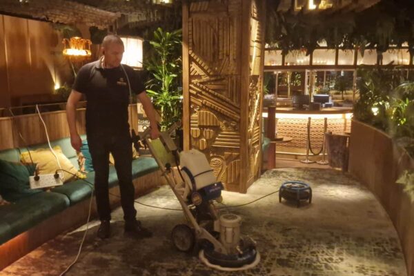 Prestige technician performing overnight wet extraction and low-moisture carpet cleaning at Amazónico restaurant, Berkeley Square, Mayfair, using Dri-Eaz fans for rapid drying.