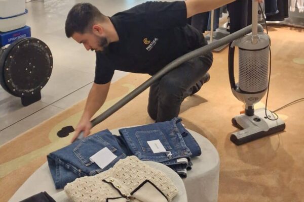 A Prestige Commercial Carpet Cleaning technician performing detailed pre-clean vacuuming on a luxury rug at Harrods, Knightsbridge.